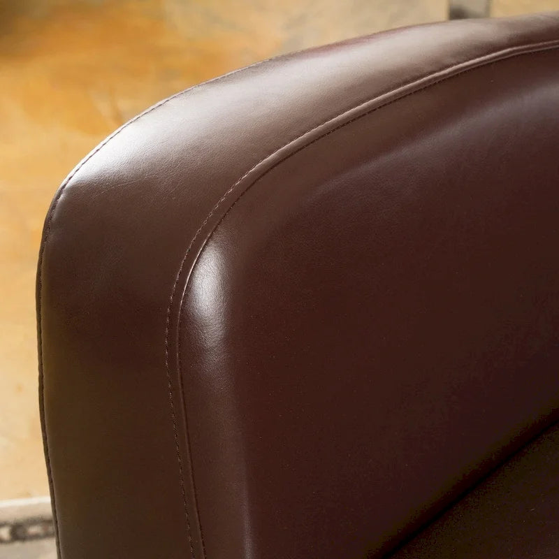 Fauteuil décoratif pivotant à dossier ailé en cuir contrecollé